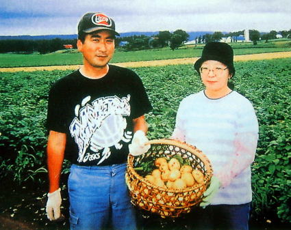 畑で収穫した自慢の今金男しゃくを見せる生産者の矢野栄さんご夫妻